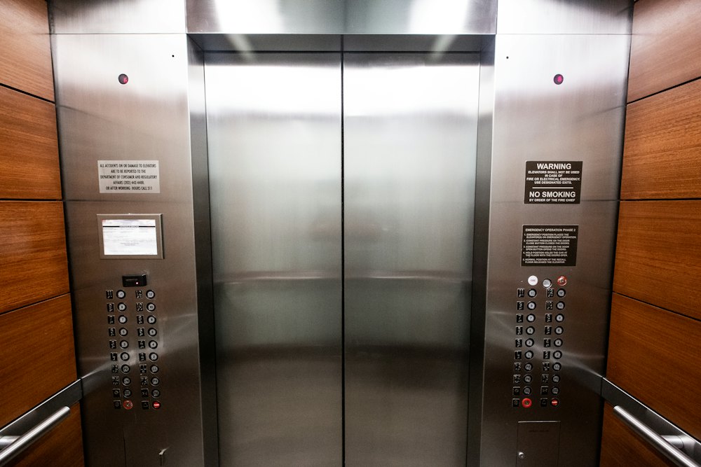 Lift cabin interior with emergency instructions and safety signage