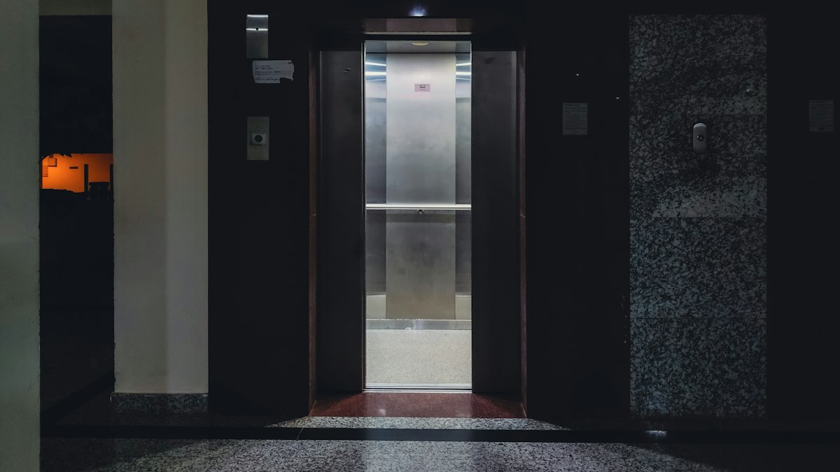 Lift doors open in a building lobby